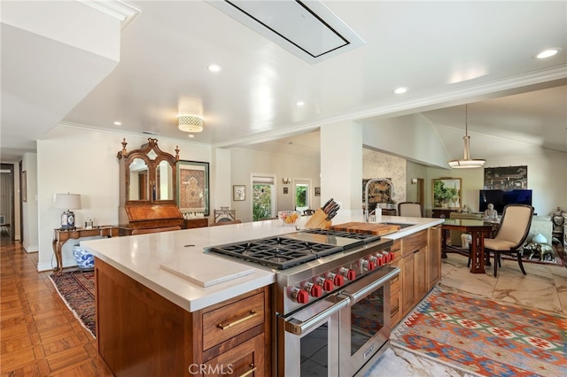 17248 Barneston Ct, Granada Hills, CA 91344 - kitchen with range with two ovens, open floor plan, brown cabinets, crown molding, and a kitchen island