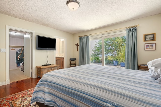 17248 Barneston Ct, Granada Hills, CA 91344 - bedroom featuring wood finished floors, a spacious closet, a textured ceiling, connected bathroom, and a closet
