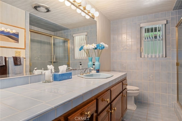 17248 Barneston Ct, Granada Hills, CA 91344 - bathroom featuring tile walls, double vanity, tiled shower, and tile patterned floors