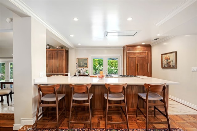 17248 Barneston Ct, Granada Hills, CA 91344 - kitchen featuring french doors, recessed lighting, light countertops, a breakfast bar, and ornamental molding
