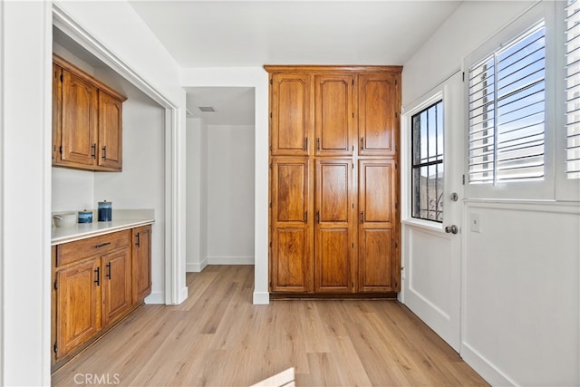 14819 San Feliciano Dr, La Mirada, CA 90638 - kitchen featuring light wood-type flooring, brown cabinetry, and light countertops