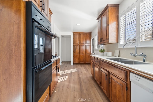 14819 San Feliciano Dr, La Mirada, CA 90638 - kitchen with white dishwasher, light wood-style floors, light countertops, and healthy amount of natural light