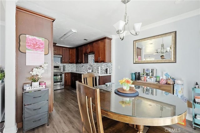 13643 Alcade St, La Puente, CA 91746 - dining room with a chandelier, wood finished floors, and crown molding