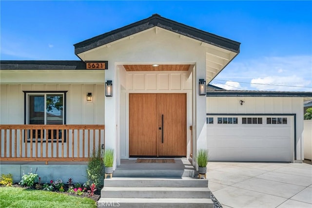 5621 E Carita St, Long Beach, CA 90808 - property entrance featuring a garage, board and batten siding, and covered porch
