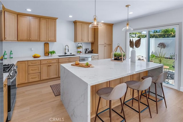 5621 E Carita St, Long Beach, CA 90808 - kitchen with stainless steel range with gas cooktop, dishwasher, recessed lighting, a kitchen bar, and light brown cabinetry