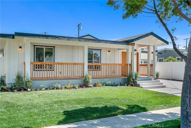 5621 E Carita St, Long Beach, CA 90808 - view of front of property featuring a porch, a front lawn, and board and batten siding