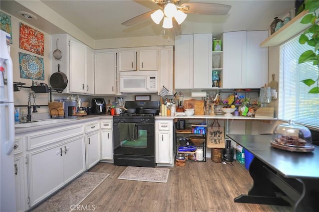 560 S 12th St, Grover Beach, CA 93433 - kitchen featuring white microwave, gas stove, white cabinets, and open shelves