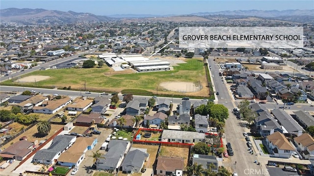 560 S 12th St, Grover Beach, CA 93433 - aerial view of property and surrounding area with a mountainous background, property parcel outlined, and nearby suburban area