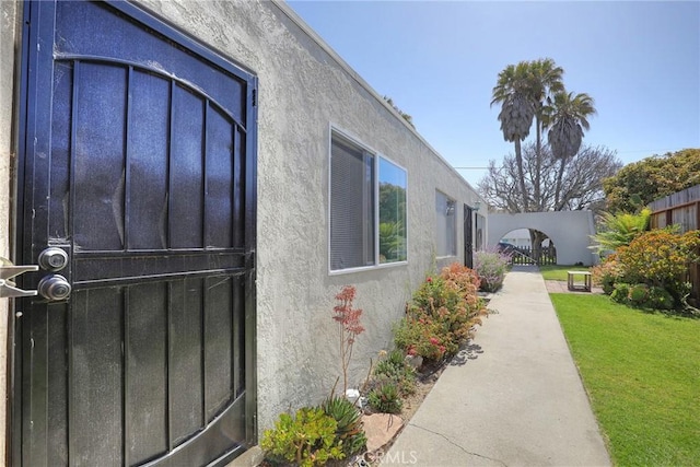 560 S 12th St, Grover Beach, CA 93433 - view of side of property with stucco siding and a yard