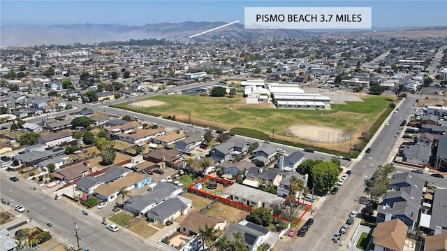 560 S 12th St, Grover Beach, CA 93433 - aerial overview of property's location featuring a mountainous background and nearby suburban area