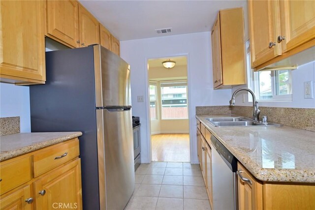 517 E Washington Blvd, Pasadena, CA 91104 - kitchen featuring stainless steel appliances, light tile patterned floors, healthy amount of natural light, and light stone counters