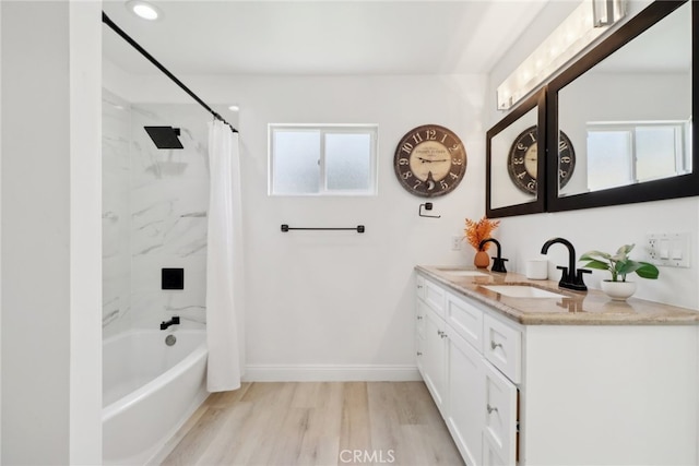 23414 Clarendon St, Woodland Hills, CA 91367 - full bath featuring double vanity, shower / tub combo, and wood finished floors