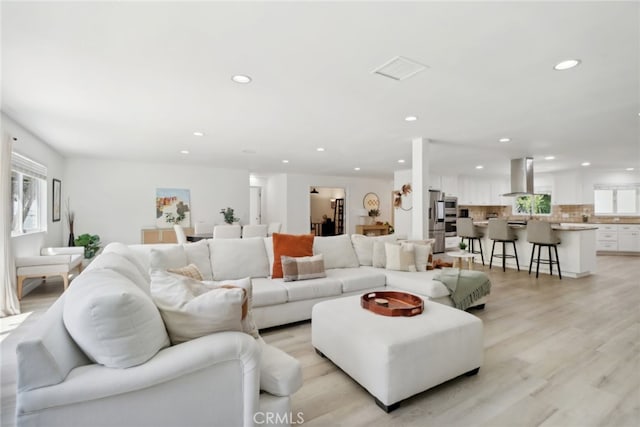 23414 Clarendon St, Woodland Hills, CA 91367 - living room featuring recessed lighting, plenty of natural light, and light wood-style floors