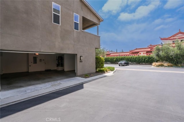 2823 Lily Ln, El Monte, CA 91733 - view of side of home with a garage and stucco siding