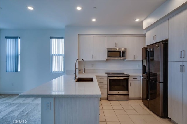 2823 Lily Ln, El Monte, CA 91733 - kitchen featuring appliances with stainless steel finishes, a peninsula, recessed lighting, and light stone counters