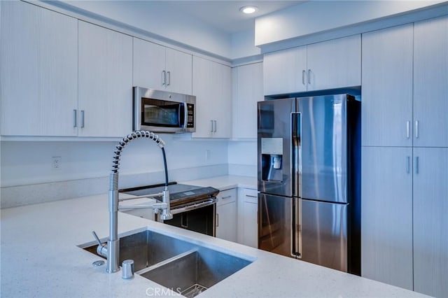 2823 Lily Ln, El Monte, CA 91733 - kitchen with appliances with stainless steel finishes, light stone countertops, and recessed lighting