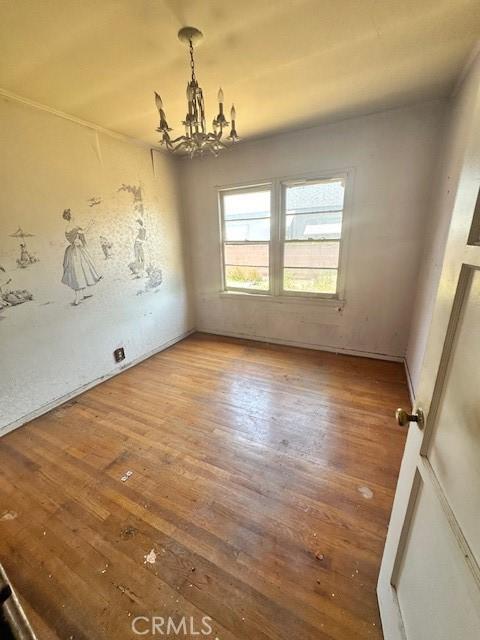 2616 E 220th Pl, Long Beach, CA 90810 - empty room featuring wood finished floors and a chandelier