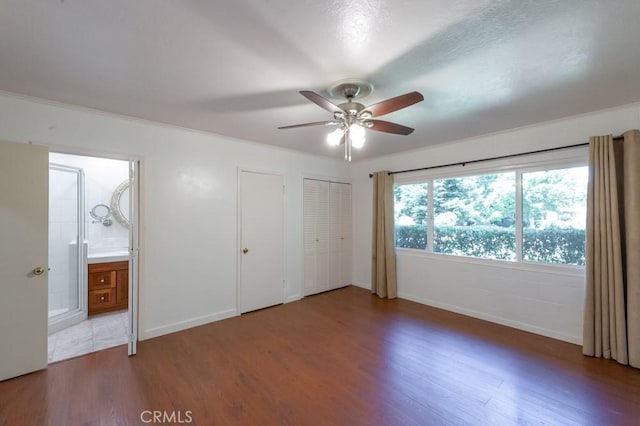 2158 N Ave, Chico, CA 95926 - unfurnished bedroom with wood finished floors, multiple closets, ensuite bath, and ceiling fan