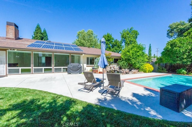 2158 N Ave, Chico, CA 95926 - back of house featuring roof mounted solar panels, a patio, and a chimney