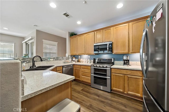 15655 Vista Way Unit 100, Lake Elsinore, CA 92532 - kitchen featuring appliances with stainless steel finishes, healthy amount of natural light, dark wood-style flooring, recessed lighting, and a peninsula