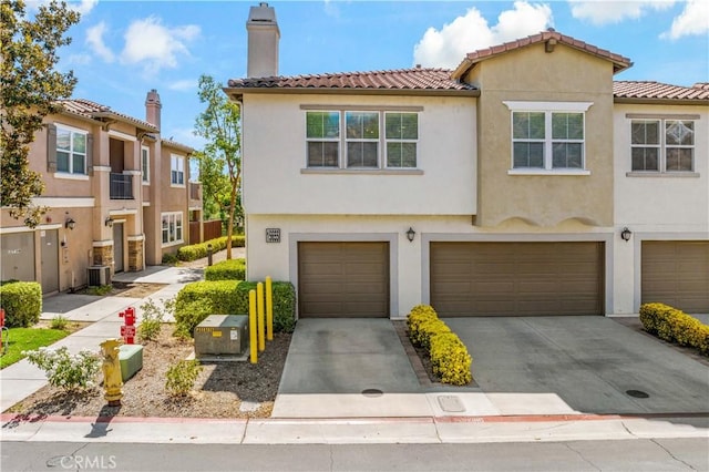 15655 Vista Way Unit 100, Lake Elsinore, CA 92532 - multi unit property featuring driveway, an attached garage, stucco siding, a chimney, and a tiled roof