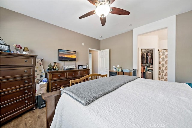 15655 Vista Way Unit 100, Lake Elsinore, CA 92532 - bedroom featuring wood finished floors, a walk in closet, a closet, and ceiling fan