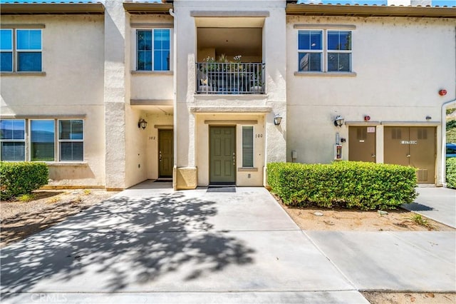 15655 Vista Way Unit 100, Lake Elsinore, CA 92532 - view of front of home with stucco siding and a balcony