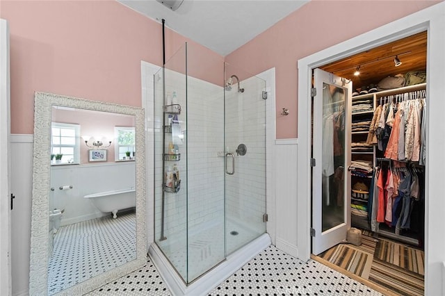 637 N 2nd Ave, Upland, CA 91786 - bathroom with wainscoting, a stall shower, a soaking tub, and a walk in closet