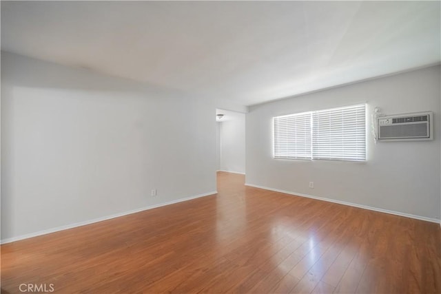 610 N Oakland Ave, Pasadena, CA 91101 - unfurnished room with a wall mounted air conditioner and wood finished floors