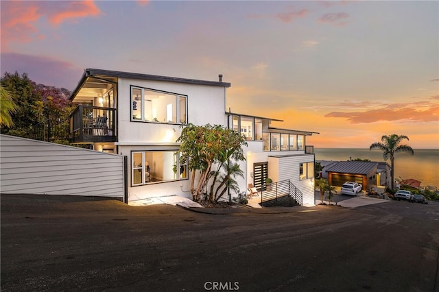 1094 Katella St, Laguna Beach, CA 92651 - view of front of house featuring a balcony, a water view, and stucco siding