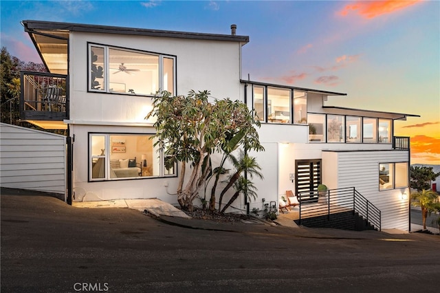 1094 Katella St, Laguna Beach, CA 92651 - contemporary house featuring a balcony, stairs, and stucco siding