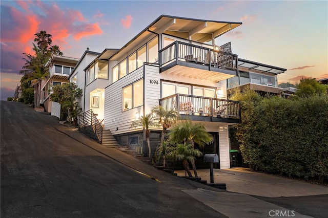 1094 Katella St, Laguna Beach, CA 92651 - view of front of home with a balcony, driveway, and an attached garage