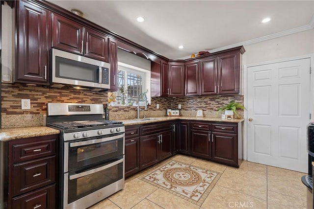 178 E 49th St, Los Angeles, CA 90011 - kitchen with stainless steel appliances, tasteful backsplash, crown molding, light tile patterned floors, and recessed lighting