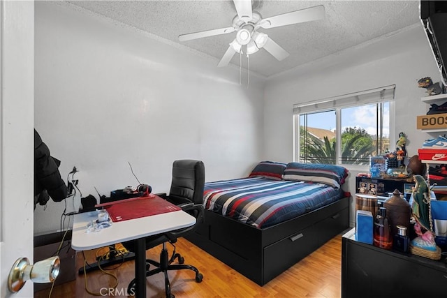 178 E 49th St, Los Angeles, CA 90011 - bedroom with a textured ceiling, wood finished floors, an office area, and ceiling fan