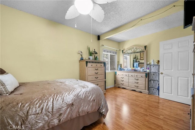 178 E 49th St, Los Angeles, CA 90011 - bedroom with light wood-style floors, a textured ceiling, and a ceiling fan