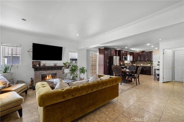 178 E 49th St, Los Angeles, CA 90011 - living room featuring a lit fireplace, light tile patterned flooring, plenty of natural light, recessed lighting, and crown molding