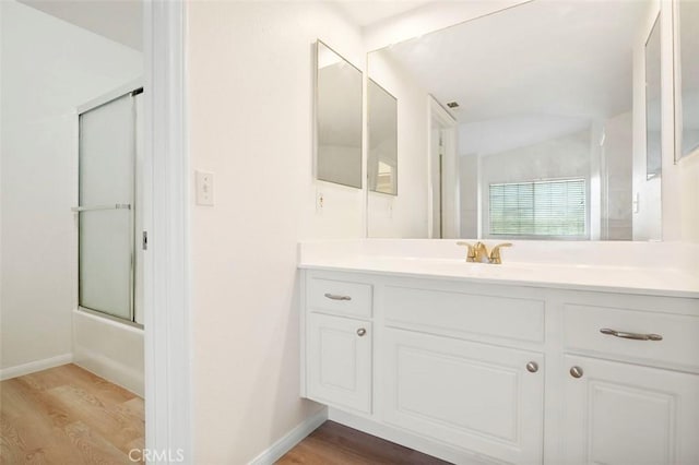 42140 Lyndie Ln Unit 12, Temecula, CA 92591 - bathroom with wood finished floors, vanity, and bath / shower combo with glass door