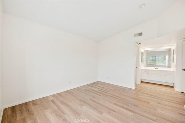 42140 Lyndie Ln Unit 12, Temecula, CA 92591 - unfurnished room with light wood-style floors, lofted ceiling, and a smoke detector