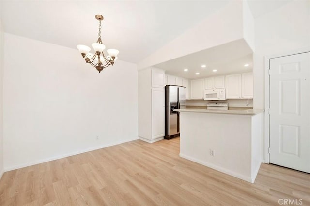 42140 Lyndie Ln Unit 12, Temecula, CA 92591 - kitchen featuring white microwave, stainless steel fridge, a chandelier, lofted ceiling, and light wood-style floors