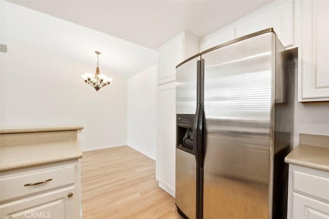 42140 Lyndie Ln Unit 12, Temecula, CA 92591 - kitchen featuring stainless steel fridge, light wood-style floors, a chandelier, and white cabinetry