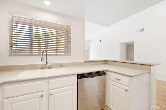 42140 Lyndie Ln Unit 12, Temecula, CA 92591 - kitchen with stainless steel dishwasher, healthy amount of natural light, white cabinets, light countertops, and recessed lighting