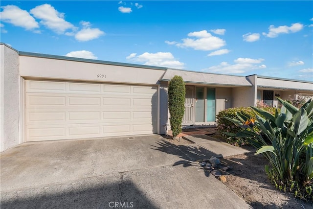 6991 Caminito Perico, San Diego, CA 92119 - view of front of house with stucco siding, driveway, and a garage