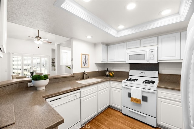 1026 N Turner Ave Unit 223, Ontario, CA 91764 - kitchen featuring white appliances, ornamental molding, white cabinets, a raised ceiling, and recessed lighting