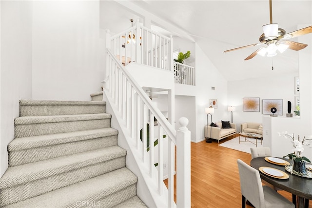 1026 N Turner Ave Unit 223, Ontario, CA 91764 - stairs featuring ceiling fan, wood finished floors, and high vaulted ceiling