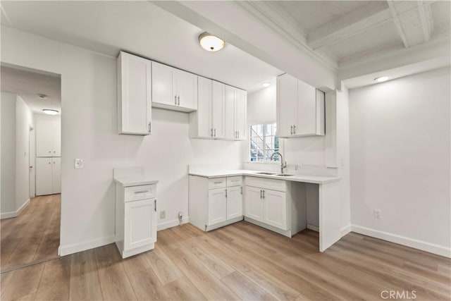 5840 S Olive St, Los Angeles, CA 90003 - kitchen with white cabinetry, light wood-style floors, and light countertops