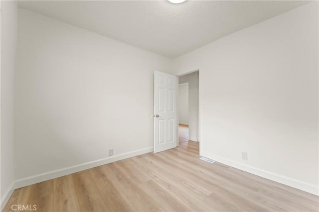 5840 S Olive St, Los Angeles, CA 90003 - spare room featuring baseboards and light wood finished floors