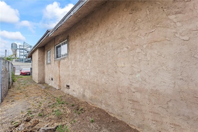 5840 S Olive St, Los Angeles, CA 90003 - view of side of property featuring stucco siding and crawl space