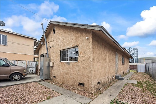 5840 S Olive St, Los Angeles, CA 90003 - view of property exterior with stucco siding and crawl space