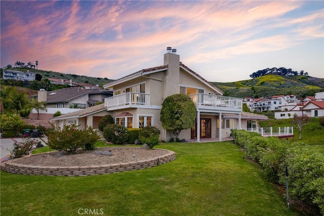 3823 Via Manzana, San Clemente, CA 92673 - back of property at dusk with a chimney, a yard, stucco siding, and a mountain view