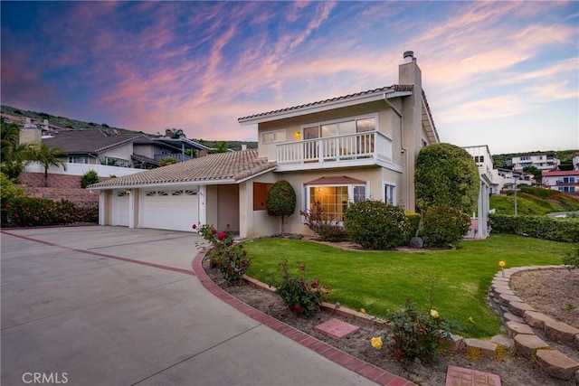 3823 Via Manzana, San Clemente, CA 92673 - view of front of property featuring a chimney, an attached garage, a balcony, concrete driveway, and stucco siding